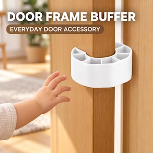 May include: A white C-shaped door frame buffer attached to a wooden door edge. The text DOOR FRAME BUFFER and EVERYDAY DOOR ACCESSORY is visible at the top. The buffer features a segmented, ribbed design to provide cushioning for the door frame.
