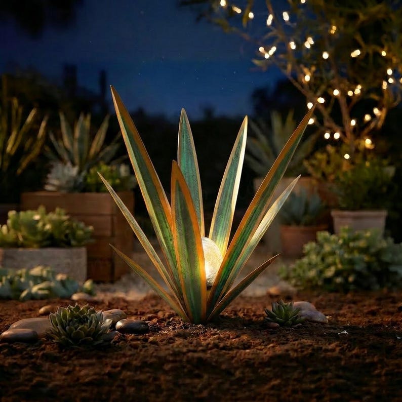 Glowing solar agave garden sculpture at night