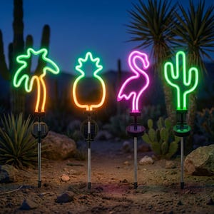 May include: Four solar-powered garden lights featuring neon-style LED shapes: a green palm tree, a yellow pineapple, a pink flamingo, and a green cactus. Each light is mounted on a thin metal stake with a small square solar panel at the base.