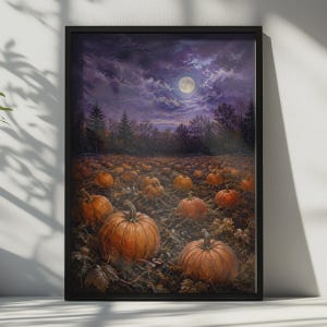 May include: A framed wall art print depicting a pumpkin patch at night under a full moon. The scene features numerous orange pumpkins resting on dark soil, surrounded by a forest silhouette under a cloudy, deep purple and blue night sky.