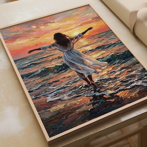 Könnte beinhalten: Ein Ölgemälde in einem hellen Holzrahmen zeigt eine Figur in einem weißen Kleid, die mit ausgebreiteten Armen in den Meereswellen steht. Die Szene zeigt einen lebhaften Sonnenuntergang mit orangefarbenen, rosa und gelben Tönen auf dem Wasser.