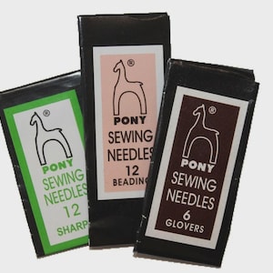 May include: Three rectangular black paper packets of Pony sewing needles. The left packet has a green label with 12 sharp needles. The center packet has a light pink label with 12 beading needles. The right packet has a dark brown label with 6 glovers needles.