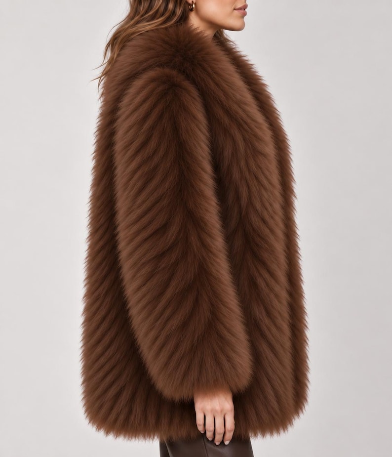 May include: A long-sleeved, hip-length coat made of thick, textured brown faux fur. The garment features a high, plush collar and a dense, shaggy pile that covers the entire exterior surface, providing a uniform, voluminous appearance throughout.