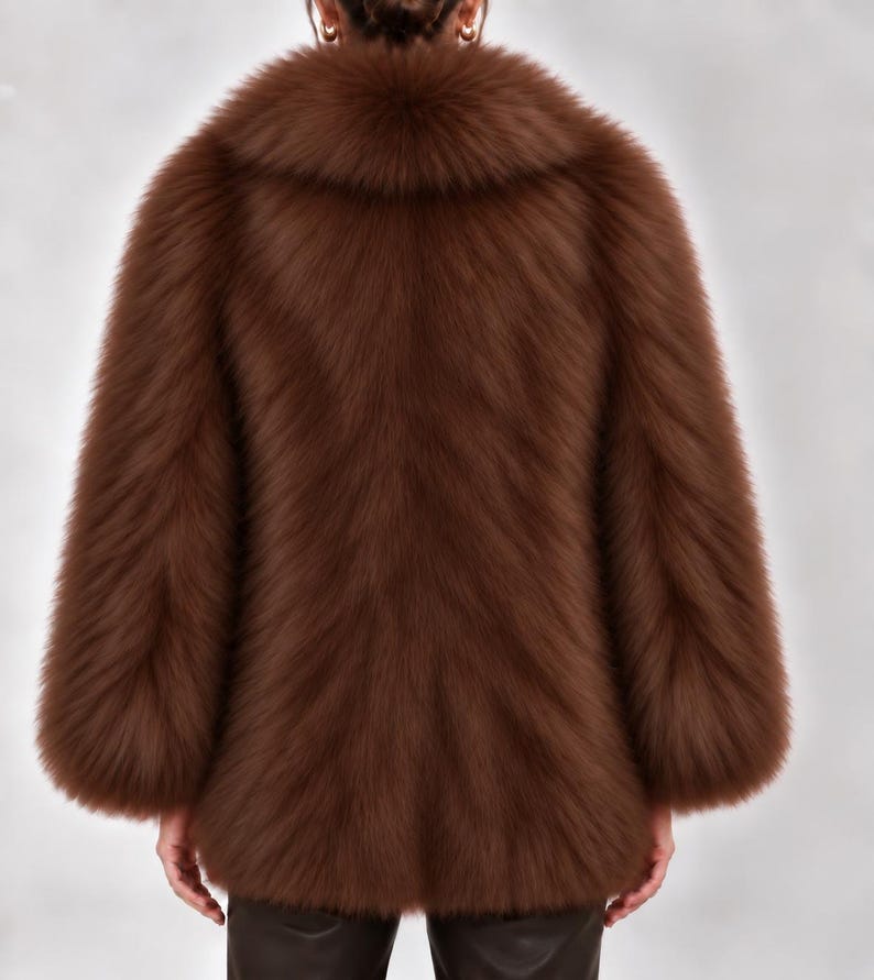 May include: A long-sleeved, hip-length jacket in a rich, deep brown color. The garment features a thick, plush, textured pile throughout the entire exterior, including a wide, rounded collar that frames the neck area, creating a voluminous silhouette.