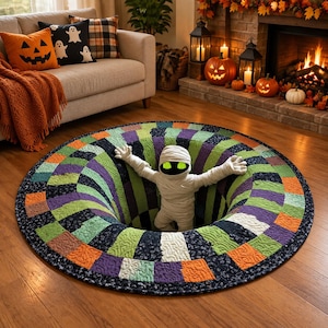 May include: A round, quilted rug featuring a 3D-effect black hole design with a patchwork pattern of orange, green, purple, and black fabric squares. A plush mummy figure with glowing green eyes emerges from the center of the rug.