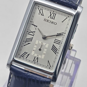 Rare Find Vintage Seiko Slim Silver Rectangular  wrist watch, Blue leather strap, Roman numerals