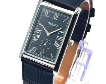 Reloj de pulsera rectangular Seiko Ultra Slim negro y plateado, con números romanos, estilo vintage, en estado casi impecable.