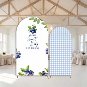 May include: Two arched backdrop covers. One features a white background with watercolor blueberry illustrations, green leaves, and the text A BERRY Sweet Baby IS ON THE WAY. The second cover features a light blue and white gingham checkered pattern.