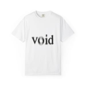 May include: A white short-sleeved t-shirt featuring the word void printed in a black, distorted, and blurred font across the centre of the chest. The garment has a standard crew neckline and a small brand label visible inside the collar area.