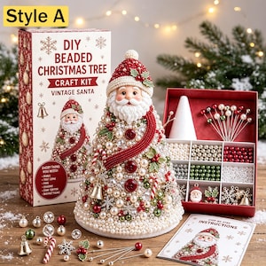 May include: A DIY beaded Christmas tree craft kit featuring a cone-shaped Santa figure decorated with red, white, and green beads, buttons, and charms. The set includes a box, a foam cone, assorted beads, pins, and an instruction card.