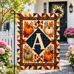 May include: A rectangular garden flag featuring a central dark blue diamond with a large cream-colored letter A. The design includes four pumpkins in orange, white, and green, surrounded by autumn leaves and berries, with a geometric border.