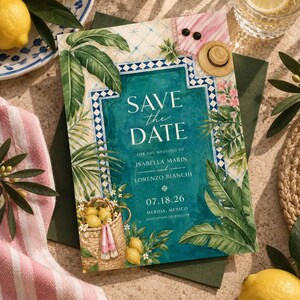 May include: A Save the Date card featuring a teal pool illustration with blue and white tile borders, surrounded by green palm leaves and a basket of lemons. The text reads Save the Date for the wedding of Isabella Marin and Lorenzo Bianchi.