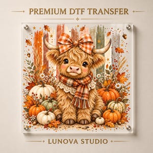 May include: A Premium DTF Transfer by Lunova Studio featuring a fluffy highland cow with a plaid bow and scarf, surrounded by autumn pumpkins, fall leaves, acorns, and berries against a vertical striped background with small stars.