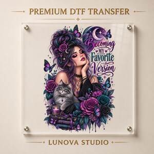 May include: A DTF transfer print featuring a person with purple-streaked hair, a fluffy grey cat, and purple roses. The text reads Becoming MY Favorite Version. The design includes butterflies, a crescent moon, and a candle on stacked books.