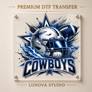 May include: A premium DTF transfer featuring a silver and blue football helmet, a football, and a large star graphic. The text reads PREMIUM DTF TRANSFER, COWBOYS, and LUNOVA STUDIO. The design includes blue and black paint splatter effects.