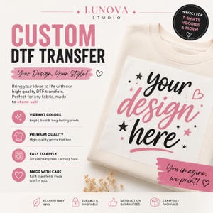 May include: A custom DTF transfer sheet featuring the text 'your design here' in black and pink script and print fonts, decorated with stars and hearts. The transfer is placed on a cream-colored sweatshirt, accompanied by promotional text.
