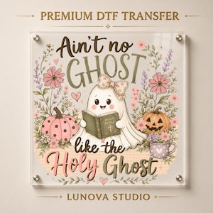 May include: A DTF transfer design featuring a white ghost with a patterned bow reading a book titled Holy Bible. The ghost is surrounded by pink polka-dot pumpkins, a jack-o'-lantern, and floral elements. The text reads Ain't no GHOST like the Holy Ghost.