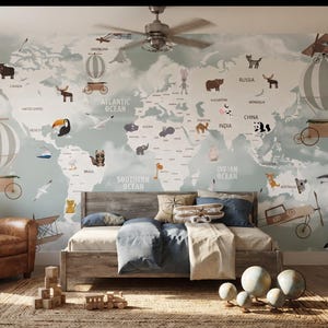 May include: A wall mural featuring a world map with illustrations of animals, hot air balloons, and airplanes in muted tones. The map includes labels for oceans and continents, covering a bedroom wall behind a wooden bed frame and leather chair.