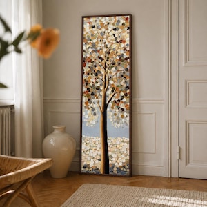 May include: A tall, rectangular wall art piece featuring a stylized tree with a dark brown trunk and branches. The foliage and ground are composed of numerous small, circular, textured paint dabs in shades of gold, orange, brown, and gray.
