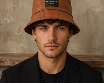 Buckethatt i konstläder, unisex accessoar med brett brätte, svartbrun