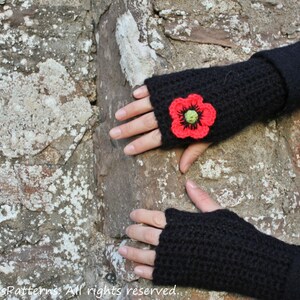 May include: Black crocheted fingerless gloves with a red poppy flower embellishment.