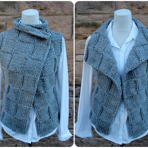 May include: A gray knitted vest with a large, folded collar. The vest has a zipper closure and a unique, textured pattern.