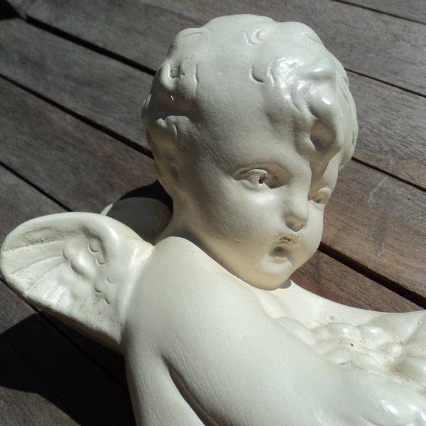 Winged large plaster cherub  for hanging/carrying armful of fruit/ all off-white except for a ribbon of gold