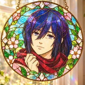 May include: A circular stained glass suncatcher featuring a portrait of a person with dark blue hair and a red scarf. The border is decorated with pink cherry blossoms and green leaves, all held together by a gold metal frame and hanging chains.