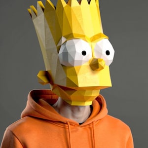 May include: A low-poly geometric mask of a cartoon character head with spiky yellow hair, large white eyes with black pupils, and a yellow skin tone. The mask is worn over the head and neck, paired with a solid orange hooded sweatshirt with drawstrings.
