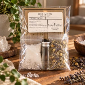 May include: A Full Moon Ritual Kit in a clear plastic bag containing a label with product contents, a small bag of coarse salt and clear quartz chips, a small glass vial with a silver cap, and a bag of dried herbs and flowers.
