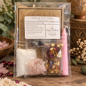 May include: A clear plastic bag containing a Love & Self Love Ritual Kit by Sage Hollow Apothecary. The kit includes a pink candle, a small bag of dried flower petals, a bag of white salt, a bag of rose quartz chips, and an instruction card.