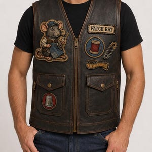 May include: A dark brown leather vest featuring a front zipper, two flap pockets, and various embroidered patches including a mouse wearing a cap, a spool of red thread, a safety pin, a measuring tape, a thimble, and the text PATCH RAT.