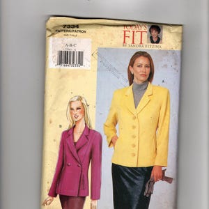 May include: A vintage sewing pattern titled "7334" featuring illustrations of two blazers. One is a double-breasted magenta blazer, and the other is a yellow blazer. The pattern is labeled "Today's Fit by Sandra Betzina."
