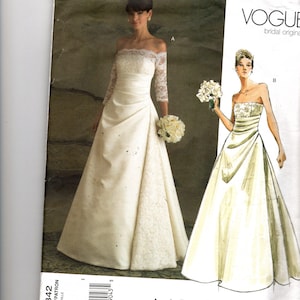 May include: Vogue bridal original pattern V2842. The image shows a woman in an off-the-shoulder wedding dress with lace sleeves and a full skirt. A second illustration depicts a strapless gown. The pattern includes sizes 6-8-10.