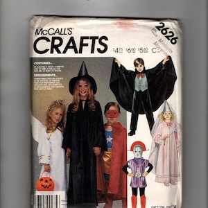 May include: A McCall's Crafts sewing pattern envelope, number 2626, size Medium. The front features illustrations of children in various costumes including a witch, vampire, angel, superhero, and wizard. Text includes "McCall's CRAFTS" and prices.