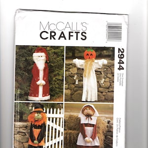 May include: McCall's Crafts pattern envelope featuring four seasonal craft projects. The projects include a Santa Claus, a scarecrow with a pumpkin head, a witch, and a colonial woman. The envelope has the number 2944.