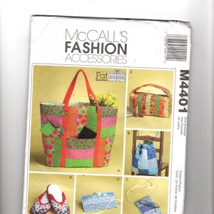 May include: A McCall's Fashion Accessories sewing pattern. The pattern features a tote bag, backpack, slippers, and other accessories. The tote bag has a floral and striped design with red handles. The pattern includes the text "Fat Quarters".