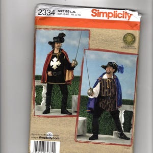 May include: Simplicity sewing pattern 2334 for a costume featuring two variations of a historical-style outfit. One version includes a black tunic with a white cross, a red cape, and a hat. The other shows a striped tunic, blue cape, and hat.