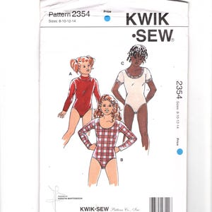 May include: A Kwik Sew pattern envelope for pattern 2354, sizes 8-10-12-14. The front shows illustrations of three leotards: a solid red long-sleeve version, a plaid long-sleeve version, and a short-sleeve version with a decorative lace-trimmed neckline.