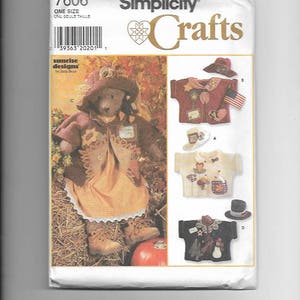 May include: A Simplicity Crafts sewing pattern for a scarecrow teddy bear. The pattern includes instructions for making a scarecrow teddy bear, a scarecrow shirt, a scarecrow hat, and a snowman shirt. The pattern is for one size.