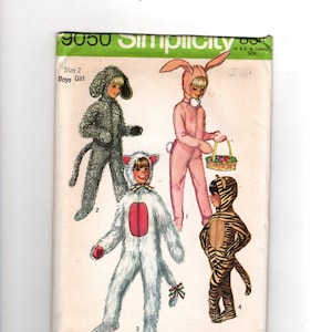 Puede incluir: Un sobre de patrón de costura Simplicity 9050 para disfraces de talla 2. La ilustración muestra a cuatro niños con disfraces de animales de cuerpo completo: un perro gris, un conejo rosa con cesta, un gato blanco y un tigre marrón.
