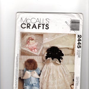 May include: McCall's Crafts sewing pattern envelope featuring angel dolls. The envelope shows a doll in a blue outfit with white wings, and another in a white dress with black hair and silver wings. The text "Faye Wine" is at the bottom.