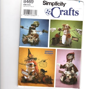 May include: A Simplicity Crafts pattern featuring four snowman designs. The designs include snowmen with hats, scarves, and various accessories. The pattern includes the text "ONE SIZE" and the number "8469".