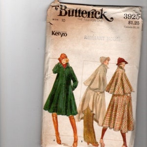 May include: A vintage sewing pattern for a women's coat. The pattern is for a long, green coat with a button-up front and a collar. The pattern also includes a shorter, beige coat with a hood and a plaid cape. The pattern is from Butterick, the fashion one, and is for size 10. The pattern number is 3925 and the price is $1.25.