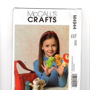 Op de afbeelding: McCall's Crafts patroon M4944 met vingerpoppetjes en een rode draagtas. De poppen zijn onder andere een kikker, beer, leeuw, eend, konijn en hond. Het patroon is voor maat OSZ.