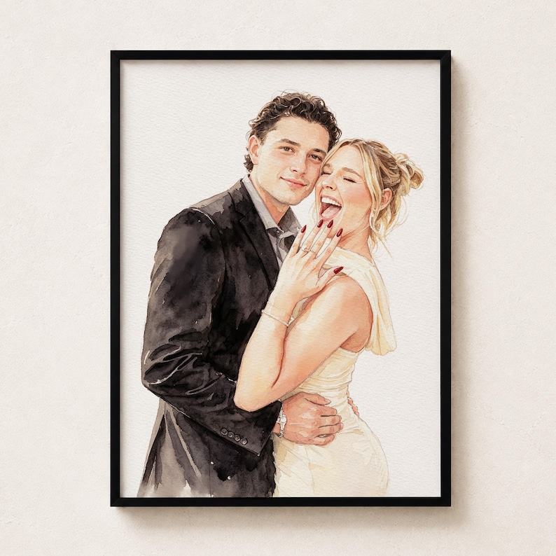 May include: A watercolour portrait of a couple in a black frame. A person in a dark suit stands behind a person in a cream-coloured dress who is laughing and holding up a hand to display a ring on their finger. The art style is soft and painterly.