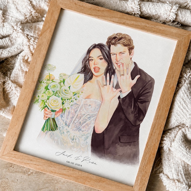 May include: A framed watercolour illustration of a couple in wedding attire. The person on the left wears a white strapless gown and veil, holding a bouquet of white flowers. The person on the right wears a dark suit. Both show rings. Text reads: Jack & Rose 08.02.2024.
