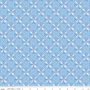 May include: A blue and white fabric with a repeating pattern of stylized flowers. The fabric has a subtle quilted texture.
