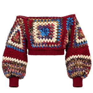 May include: An off-the-shoulder long-sleeve crop top made of multicolored crochet granny squares. The garment features a deep burgundy base color with accents of cream, blue, and brown. It has ribbed cuffs and a ribbed hem in solid burgundy.