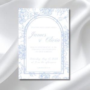 May include: A rectangular wedding invitation card featuring a light blue floral and dragonfly line art border. The centre displays an arched frame with the text: Together with their families, James & Olivia, request your presence at the ceremony and celebration of their marriage, Saturday May 15, 2028 at 3 in the afternoon, Virginia Beach.